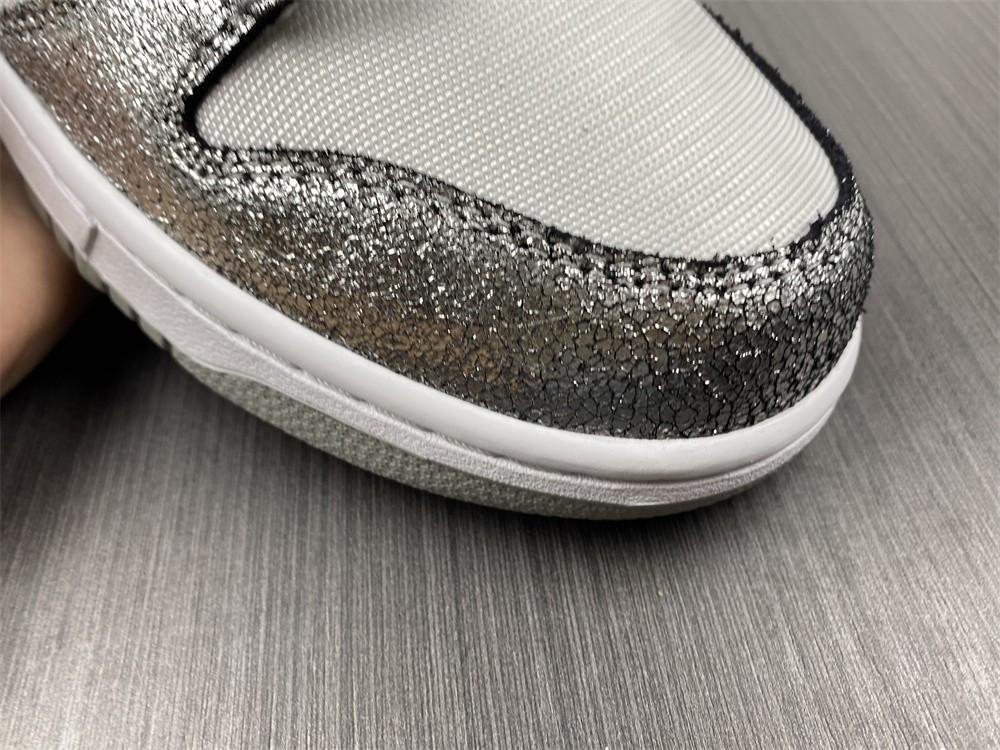 the nike dunk low features silver cracked leather do5882-001