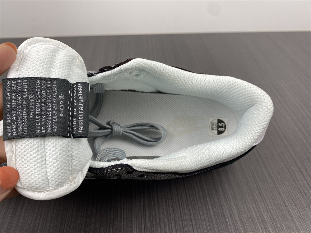 the nike dunk low features silver cracked leather do5882-001